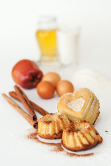 Heart-shaped cake and ingredients for baking