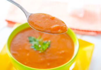Fresh soup from pumpkin in the green bowl