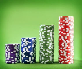 Chips for poker on the green background
