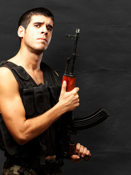 Portrait Of Soldier Holding Gun