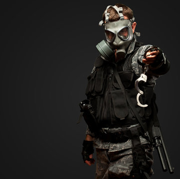 Soldier With  A Gas Mask Holding Handcuffs
