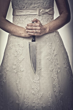 bride holding  kitchen knife her hands. concept hostility, aggression domestic danger.