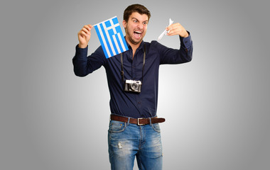 Man holding flag and miniature airplane