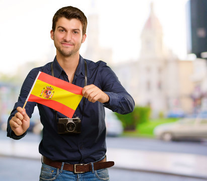 Portrait of a young man holding a flag