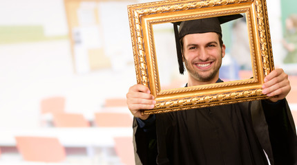 Graduate man looking through a frame