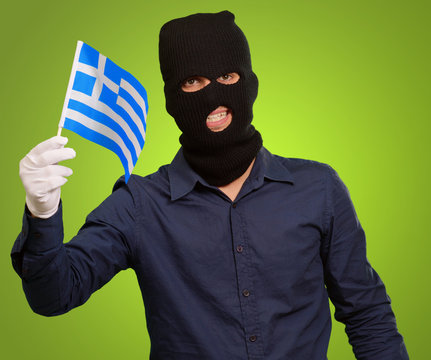 Man wearing robber mask and holding flag