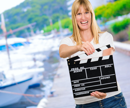 Happy Woman Holding Clapper Board