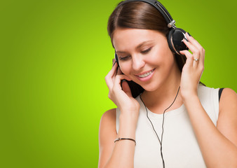 Naklejka premium Young Woman Listening to Music
