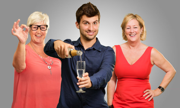Man Pouring Wine While Woman Gesturing Behind