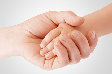 Mother holding child's hand