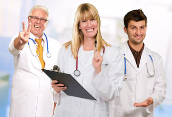 Fototapeta premium Happy Female Doctor Holding Clipboard Infront Of Happy Male Doct