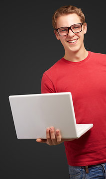 casual man holding laptop