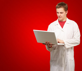 Portrait of a doctor surfing on laptop