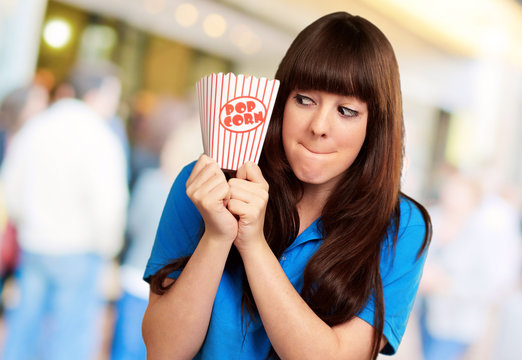 girl holding empty popcorn packet
