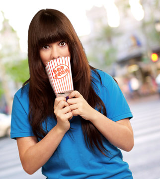 girl holding empty popcorn packet