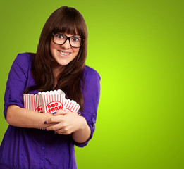 Portrait Of Young Woman Holding Popcorn Container