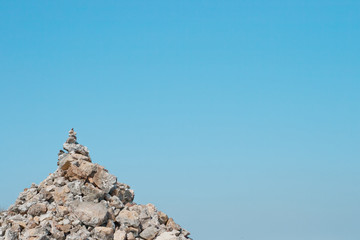 One pyramid of stones against the blue sky