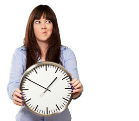 A Young Girl Holding A Clock And Making Face