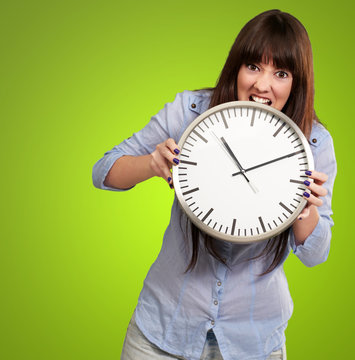 A Young Girl Holding A Clock And Angry