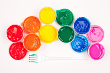 motley paints on the white background. paints arranged as rainbo