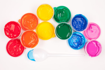 motley paints on the white background. paints arranged as rainbo
