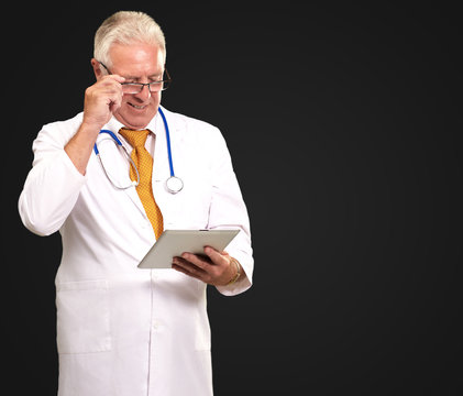 Portrait Of A Male Doctor Holding A Tab