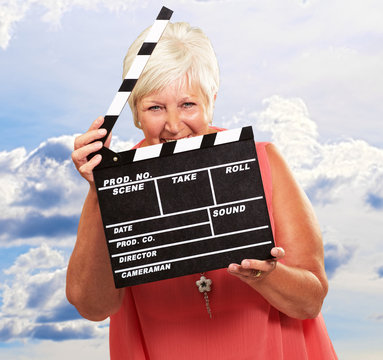 Senior Woman Holding Clapper