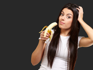 A Young Woman Holding A Banana