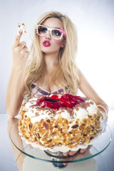 Beautiful blonde woman with a cake