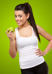 Young woman holding and eating an apple