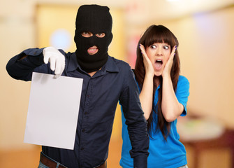 Burglar Man Holding Paper In Front Scared Woman