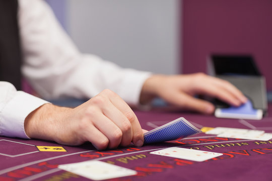 Dealer Distributing Cards In A Casino