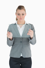 Businesswoman studying glass pane