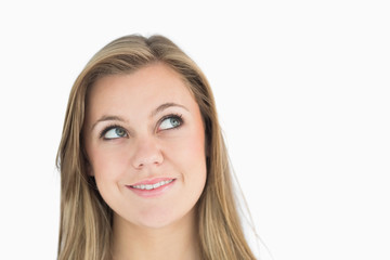 Thoughtful blonde woman smiling