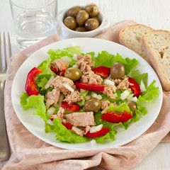 tuna salad on the plate and olives in the bowl