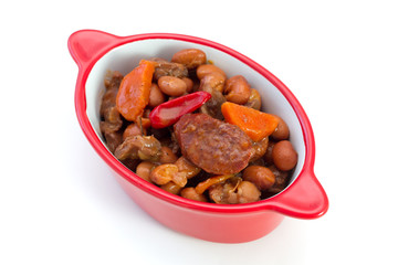 meat with sausages and beans in the bowl on white background