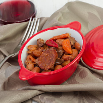 meat stew with sausages with glass of wine