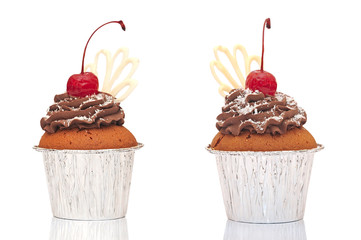 Muffins in a container  with chocolate cream, cherries and crumb