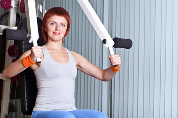 woman make exercise on training apparatus