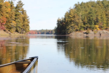 Bow of canoe on calm lake.