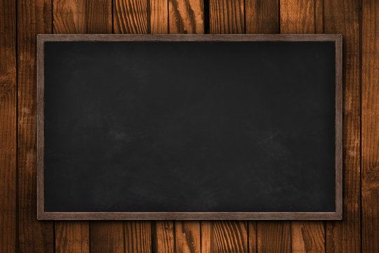 Blank blackboard on wooden wall