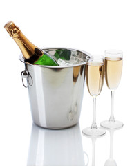 Champagne bottle in bucket with ice and glasses of champagne,