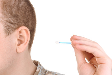 Human ear and cotton swabs close-up isolated on white