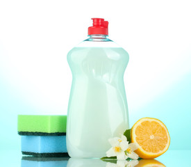 Dishwashing liquid with sponges and lemon with flowers