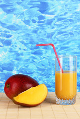 Ripe appetizing mango on woven napkin on water background