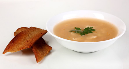 Fragrant soup with garlic croutons isolated on white