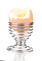 boiled egg in egg cup isolated on white
