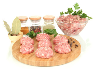 Raw meatballs with spices isolated on white