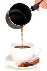 Pouring coffee in cup isolated on white
