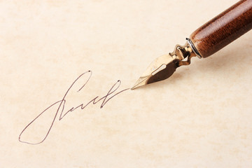 Closeup of signature (fake, not real) and ink pen, on old paper